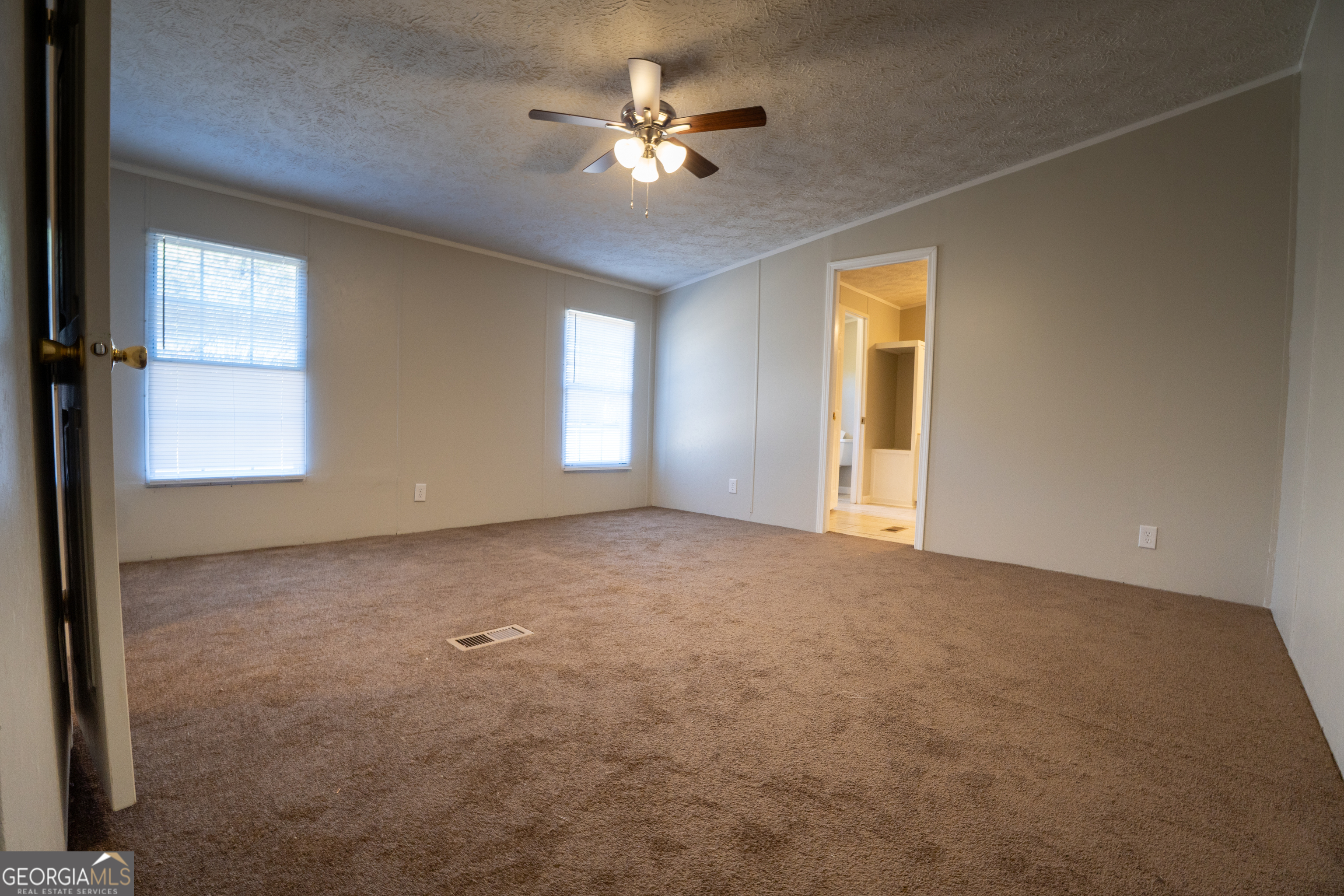 1100 Sapp Road Dry Branch, GA 31020 - Photo 13 of 54 a view of a room with a ceiling fan and a window