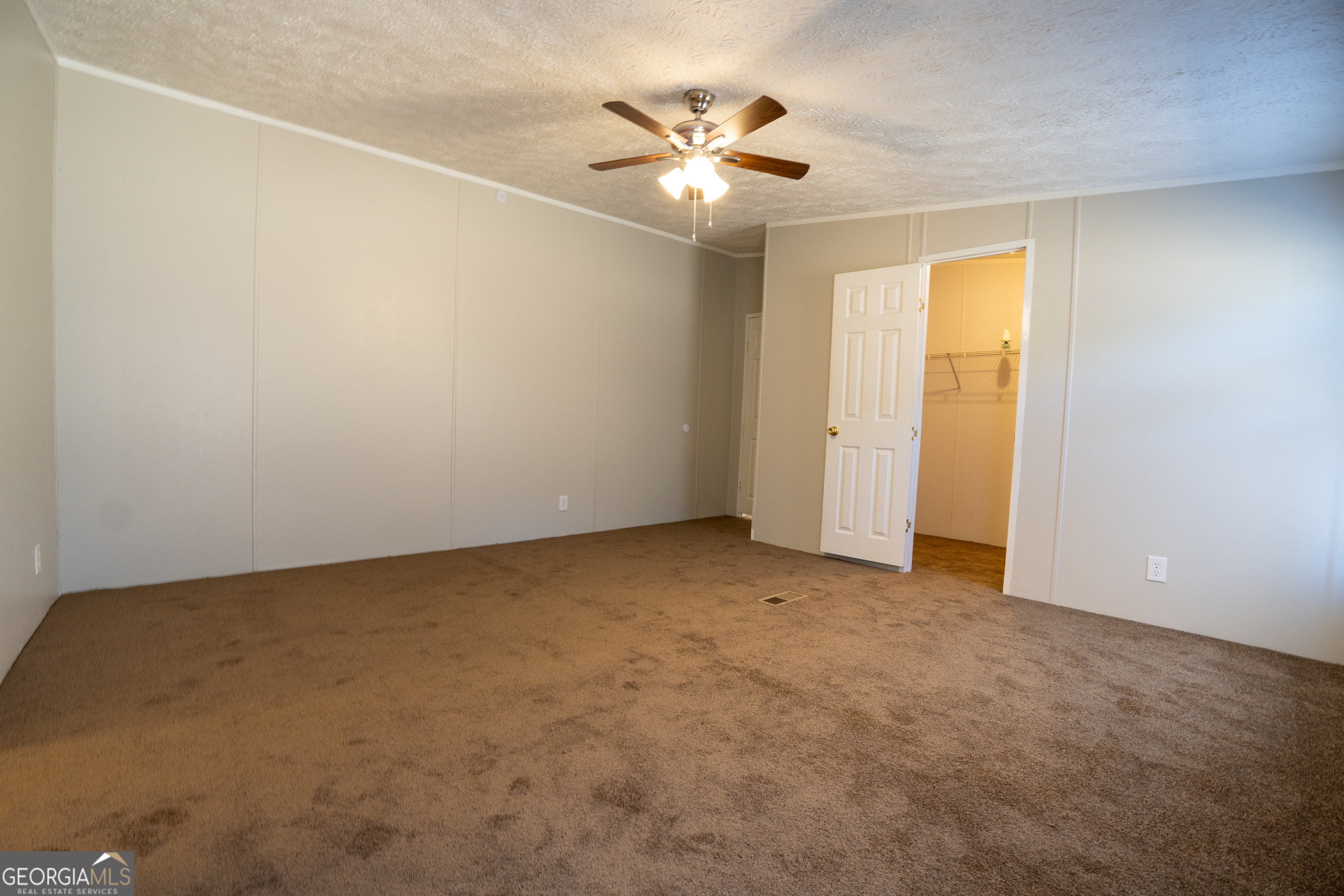 1100 Sapp Road Dry Branch, GA 31020 - Photo 14 of 54 an empty room with a ceiling fan and window