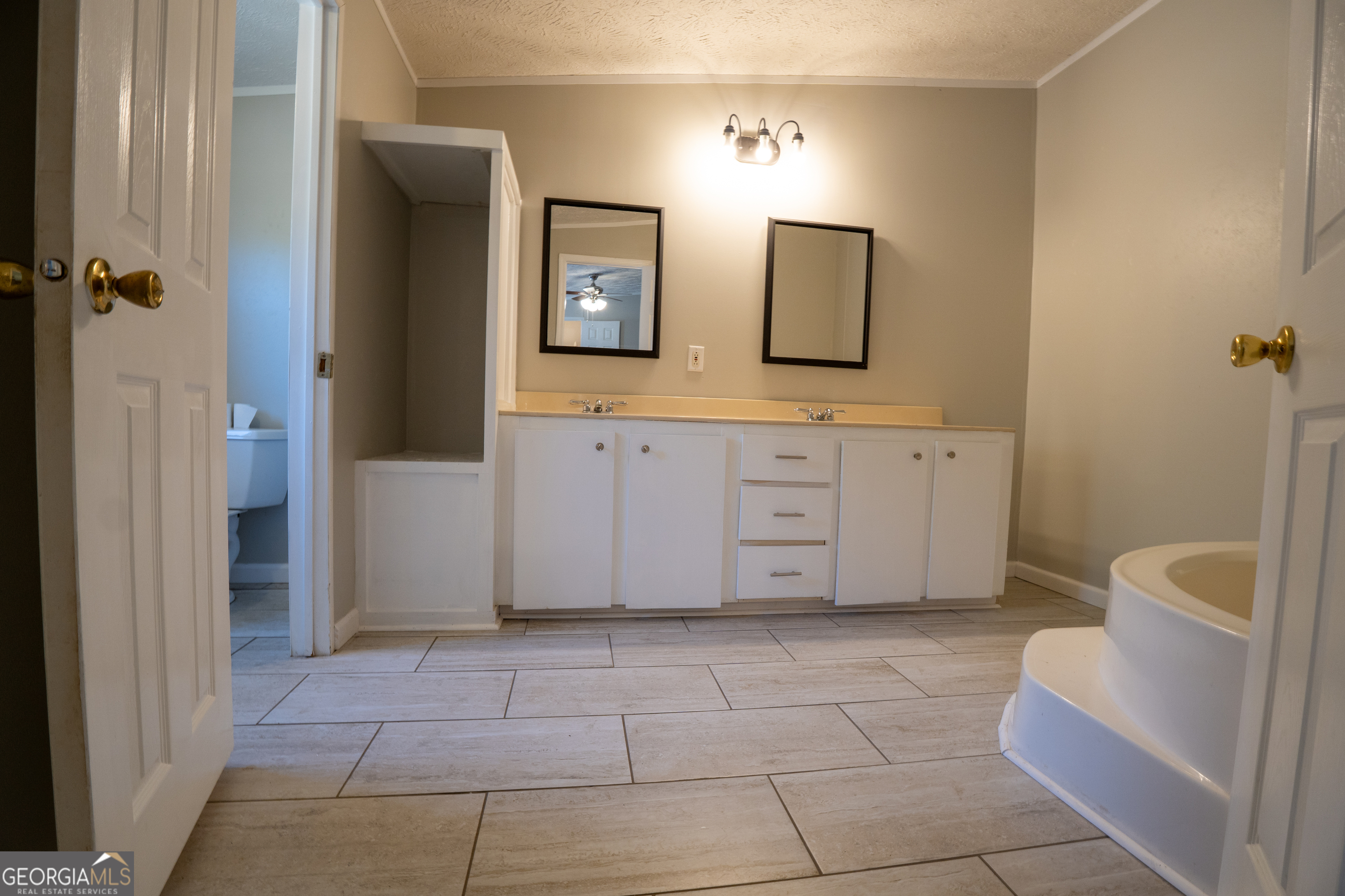 1100 Sapp Road Dry Branch, GA 31020 - Photo 15 of 54 a spacious bathroom with a mirror and a bathtub