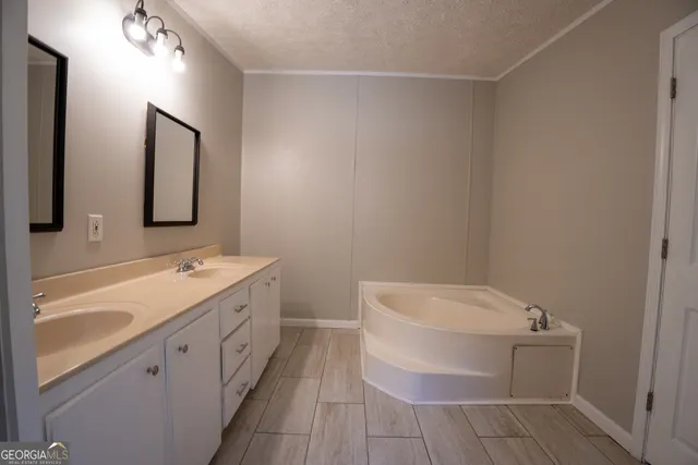 a bathroom with a double vanity sink and mirror