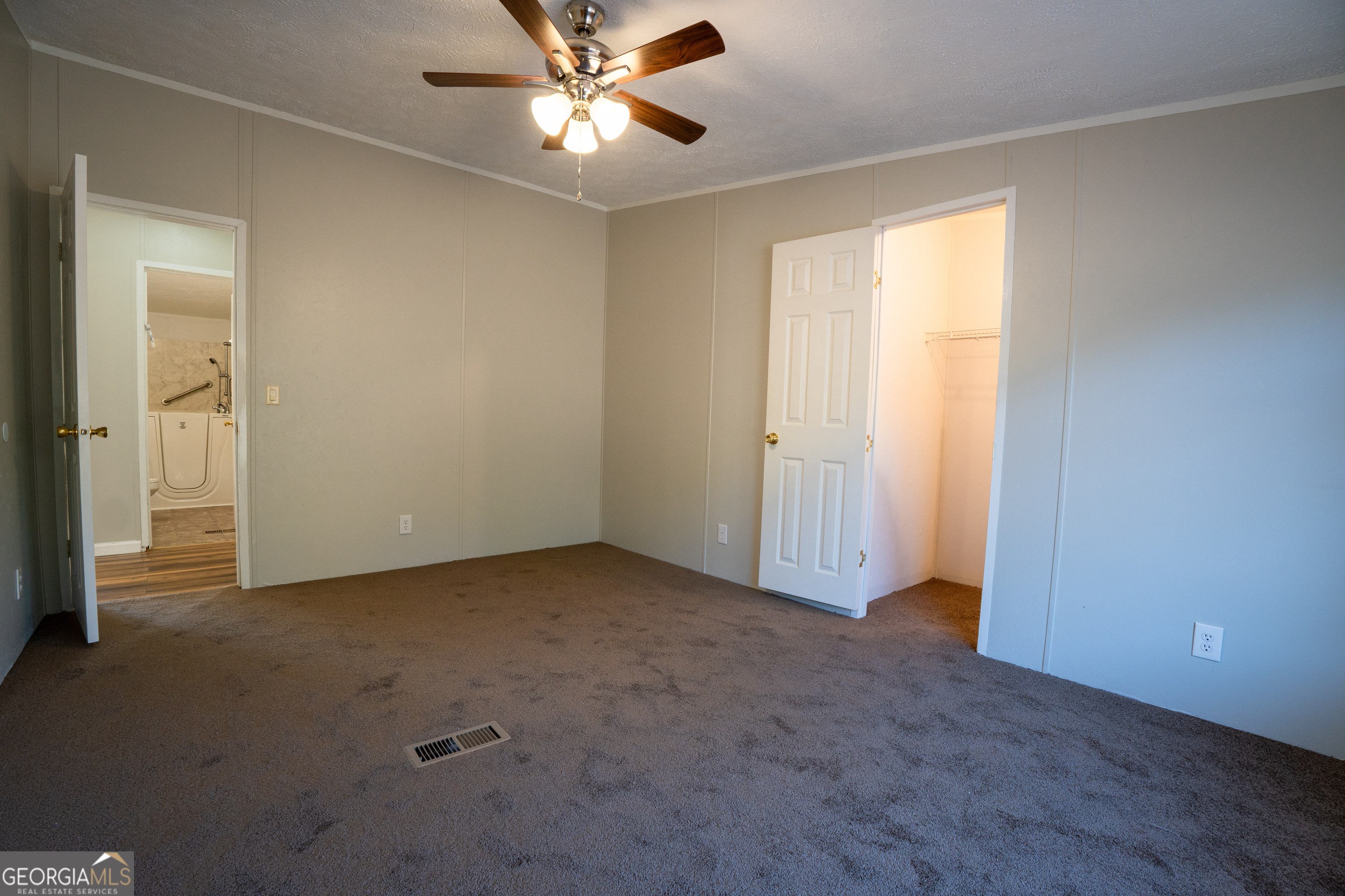 1100 Sapp Road Dry Branch, GA 31020 - Photo 23 of 54 an empty room with windows and fan