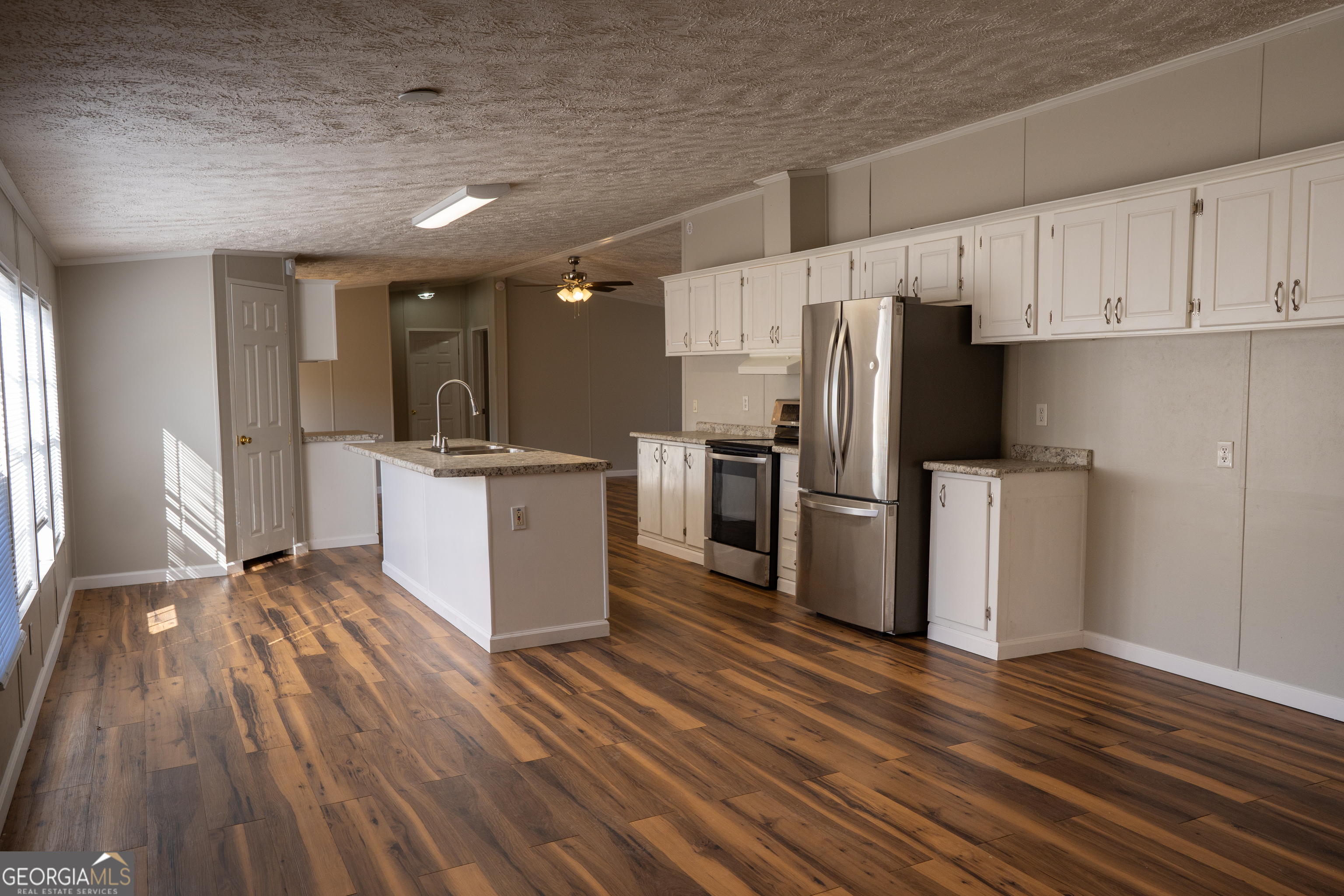 1100 Sapp Road Dry Branch, GA 31020 - Photo 5 of 54 a kitchen with stainless steel appliances a refrigerator sink and cabinets