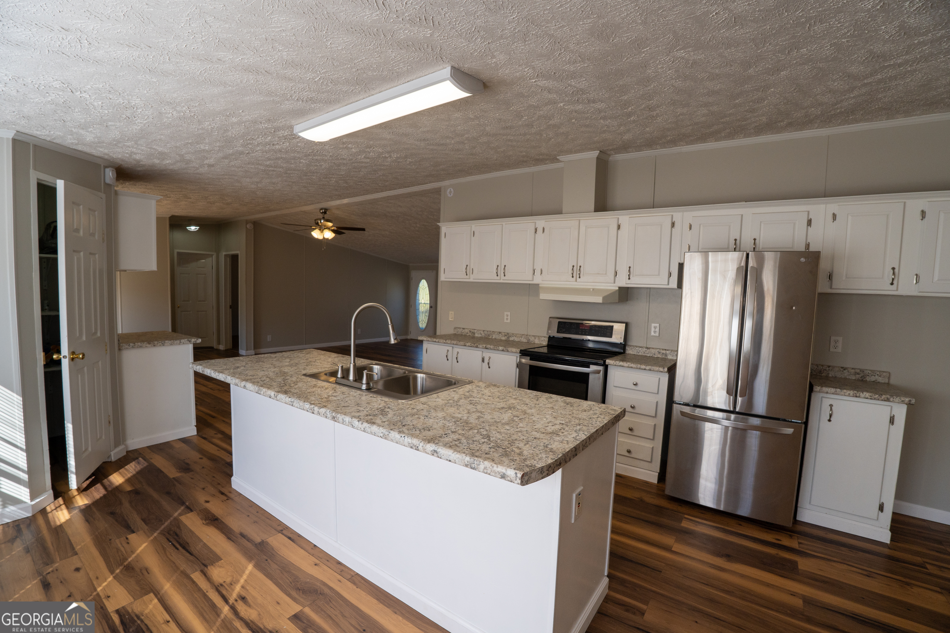 1100 Sapp Road Dry Branch, GA 31020 - Photo 6 of 54 a kitchen with kitchen island a sink stove and refrigerator