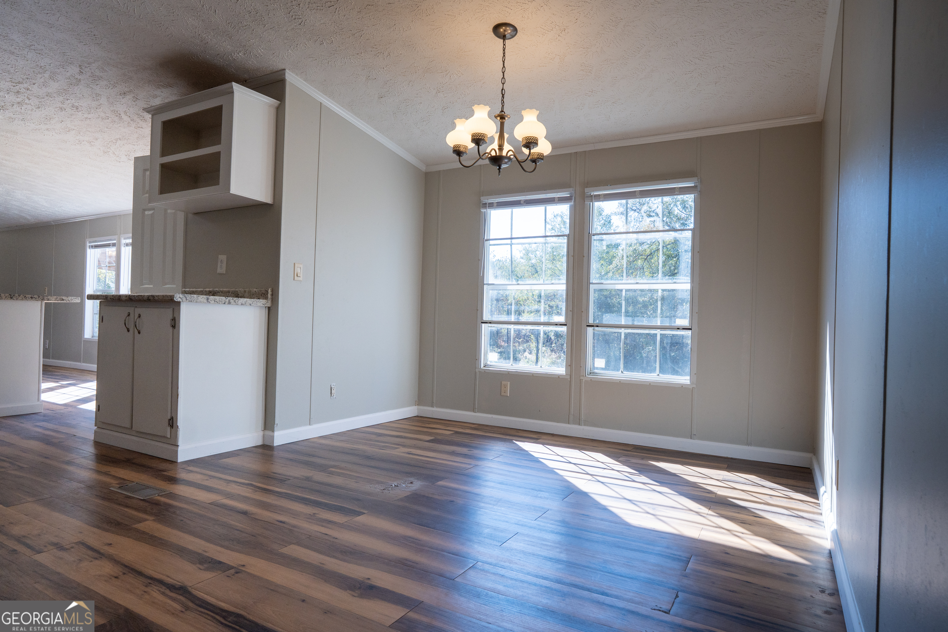1100 Sapp Road Dry Branch, GA 31020 - Photo 10 of 54 a view of an empty room with wooden floor and a window