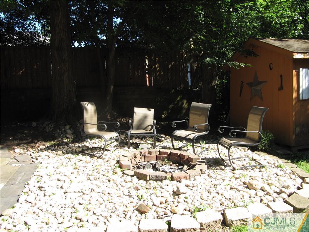 19 Glendale Road Colonia, NJ 07067 - Photo 22 of 24 a view of a backyard with table and chairs and potted plants
