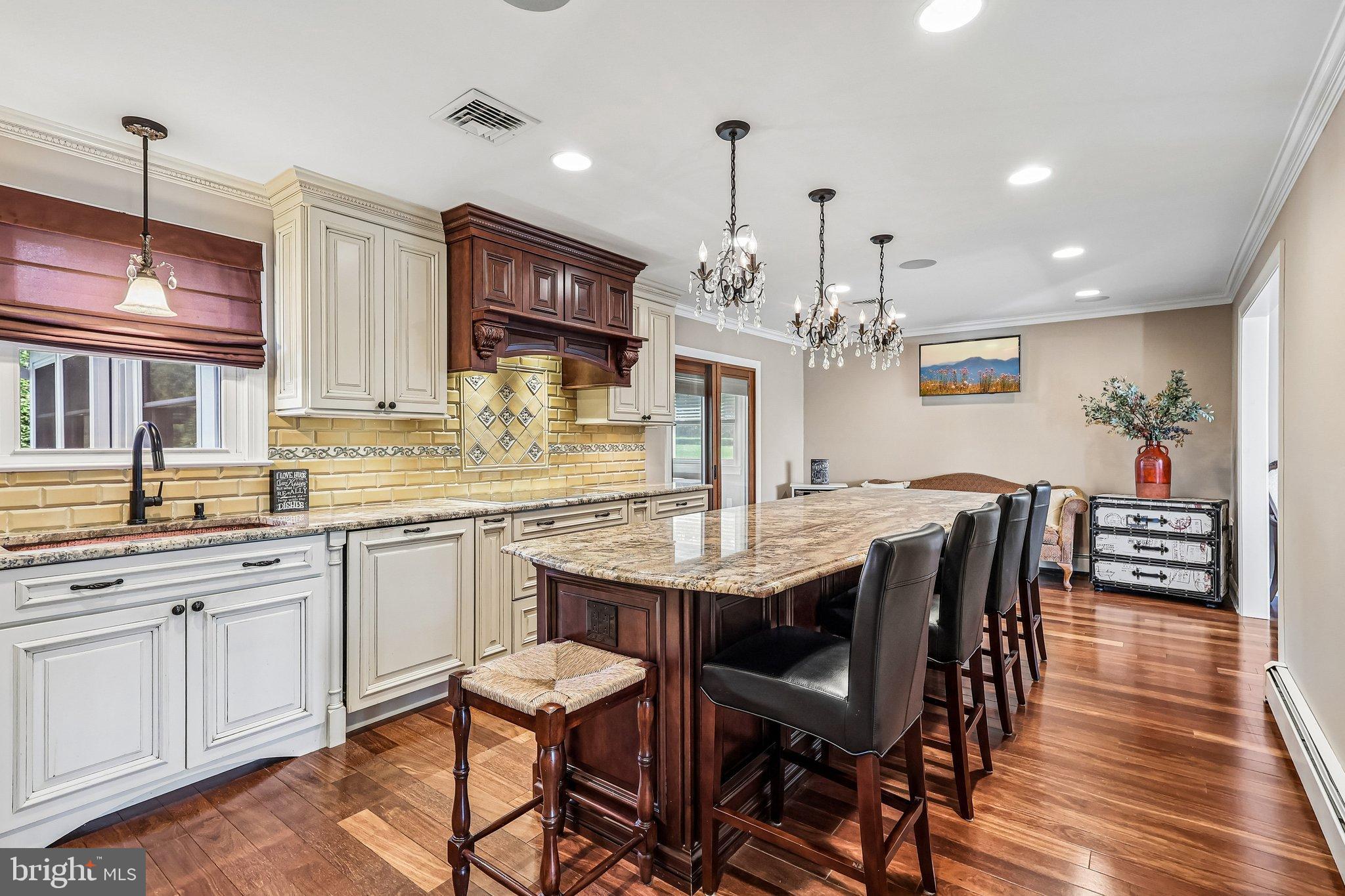 2291 Packard Avenue Huntingdon Valley, PA 19006 - Photo 5 of 38 a kitchen with stainless steel appliances granite countertop a kitchen island a stove a table and chairs in it