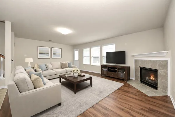 a living room with furniture a fireplace and a flat screen tv