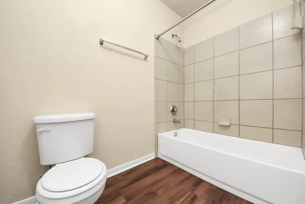 a bathroom with a toilet and bathtub