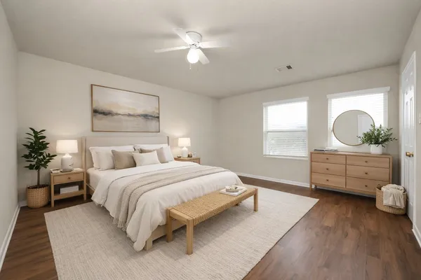 a bedroom with a bed mirror and window