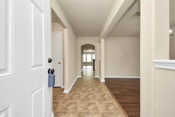 a view of a hallway with wooden floor and staircase