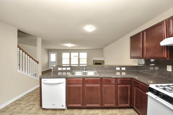 a kitchen with granite countertop a sink and a stove