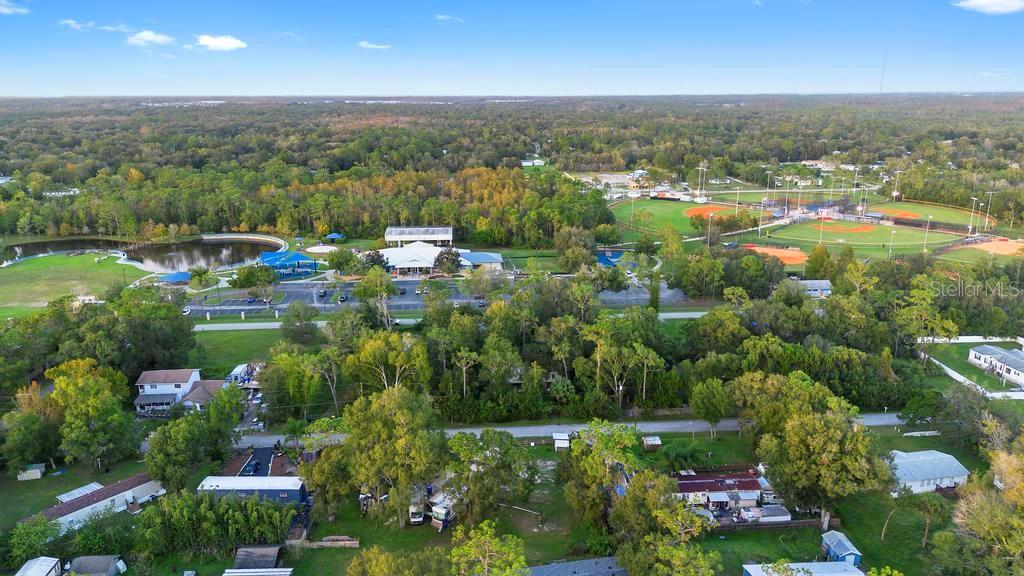 1st Avenue Orlando, FL 32820 - Photo 3 of 6 an aerial view of a houses with a yard and lake view