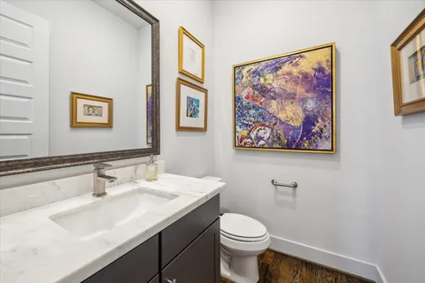 a bathroom with a toilet a sink and mirror