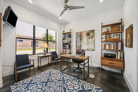 a living room with furniture a rug and a flat screen tv