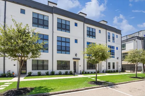 a front view of building with yard and green space