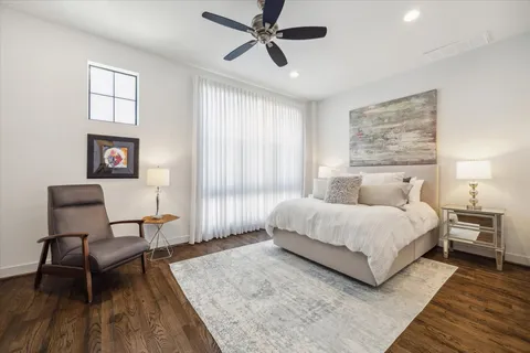 a spacious bedroom with a bed a couch and a window