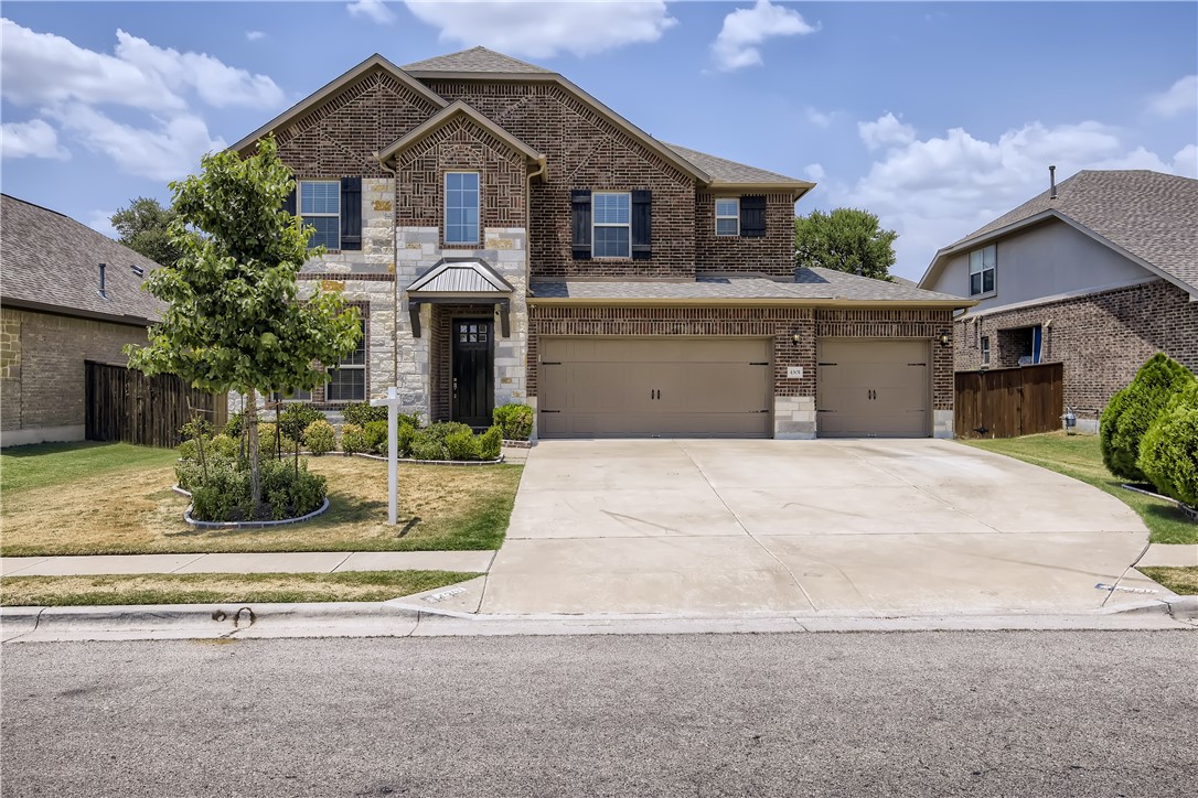 4301 Trinity Woods Street Leander, TX 78641 - Photo 1 of 1 a front view of a house with garden