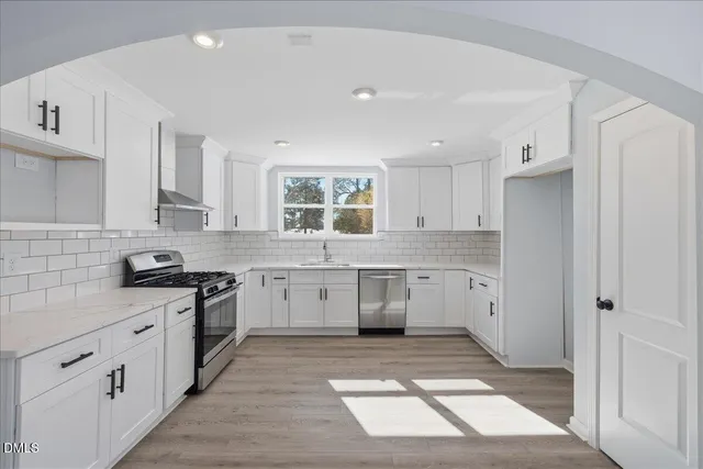 a kitchen with a stove a sink and a refrigerator