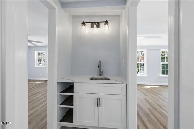 a bathroom with a sink a mirror and shower