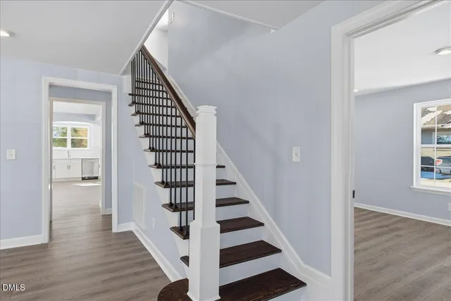 a view of entryway with wooden floor and stairs