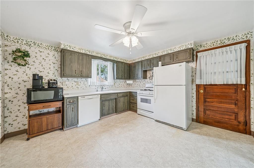 805 Willow Street Irwin, PA 15642 - Photo 15 of 33 a kitchen with granite countertop cabinets and white appliances