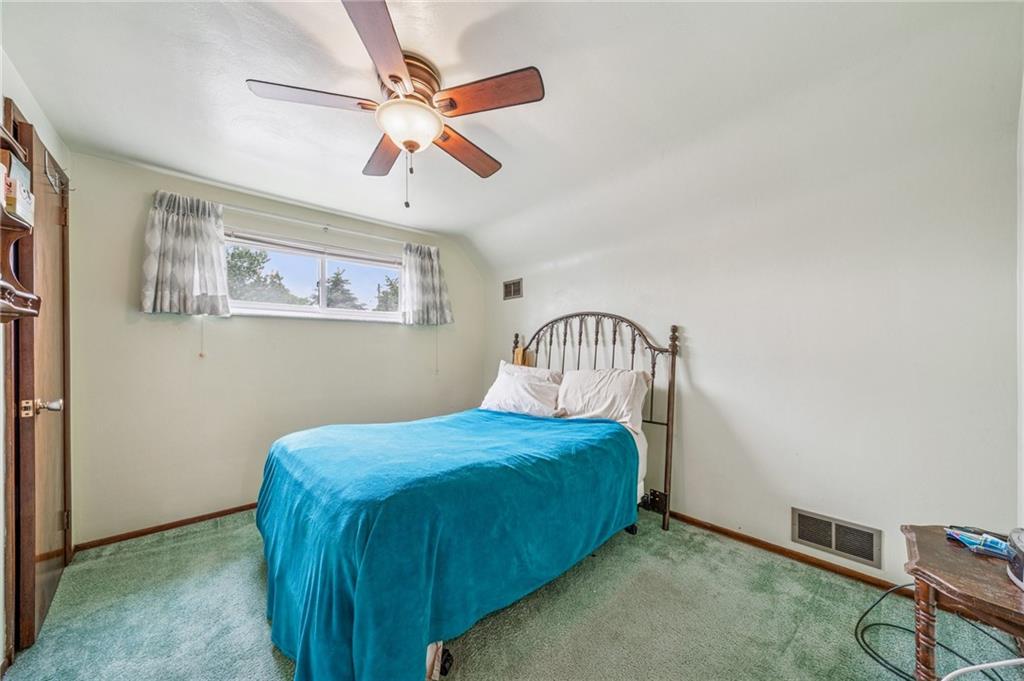 805 Willow Street Irwin, PA 15642 - Photo 20 of 33 a bedroom with a bed and a chandelier