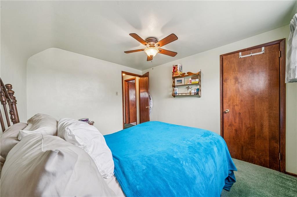 805 Willow Street Irwin, PA 15642 - Photo 21 of 33 a bedroom with a large bed and a chandelier