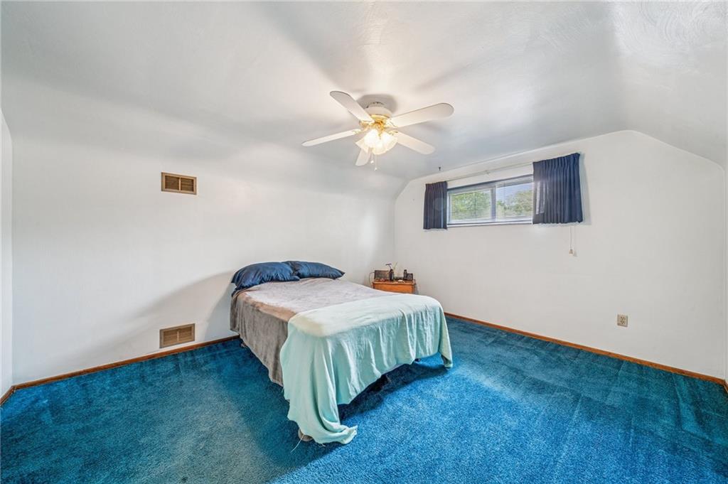 805 Willow Street Irwin, PA 15642 - Photo 22 of 33 a bedroom with a bed chandelier and a window