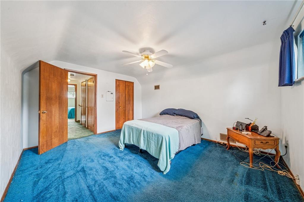 805 Willow Street Irwin, PA 15642 - Photo 23 of 33 a spacious bedroom with a bed and a chandelier