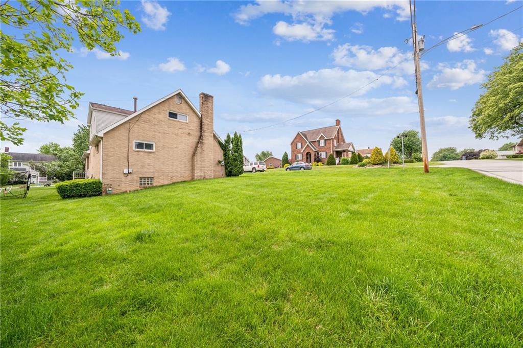 805 Willow Street Irwin, PA 15642 - Photo 33 of 33 a view of a big house with a big yard and large tree
