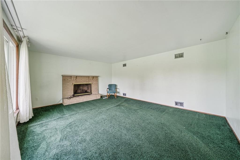 805 Willow Street Irwin, PA 15642 - Photo 4 of 33 a view of an empty room with a fireplace and a window