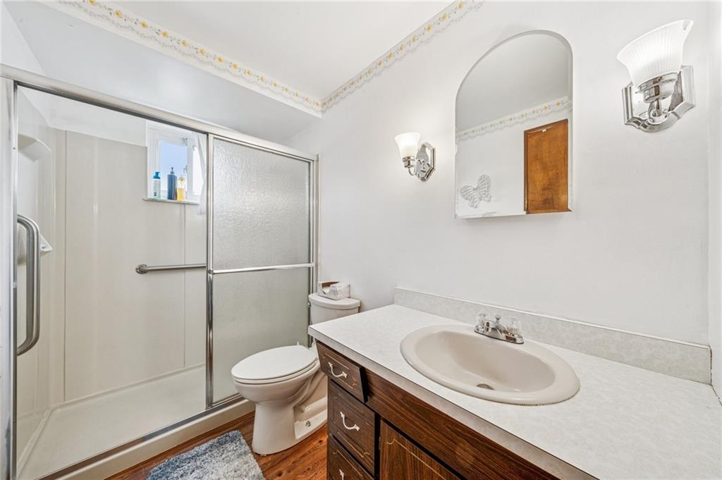 805 Willow Street Irwin, PA 15642 - Photo 8 of 33 a bathroom with a toilet sink a mirror and shower