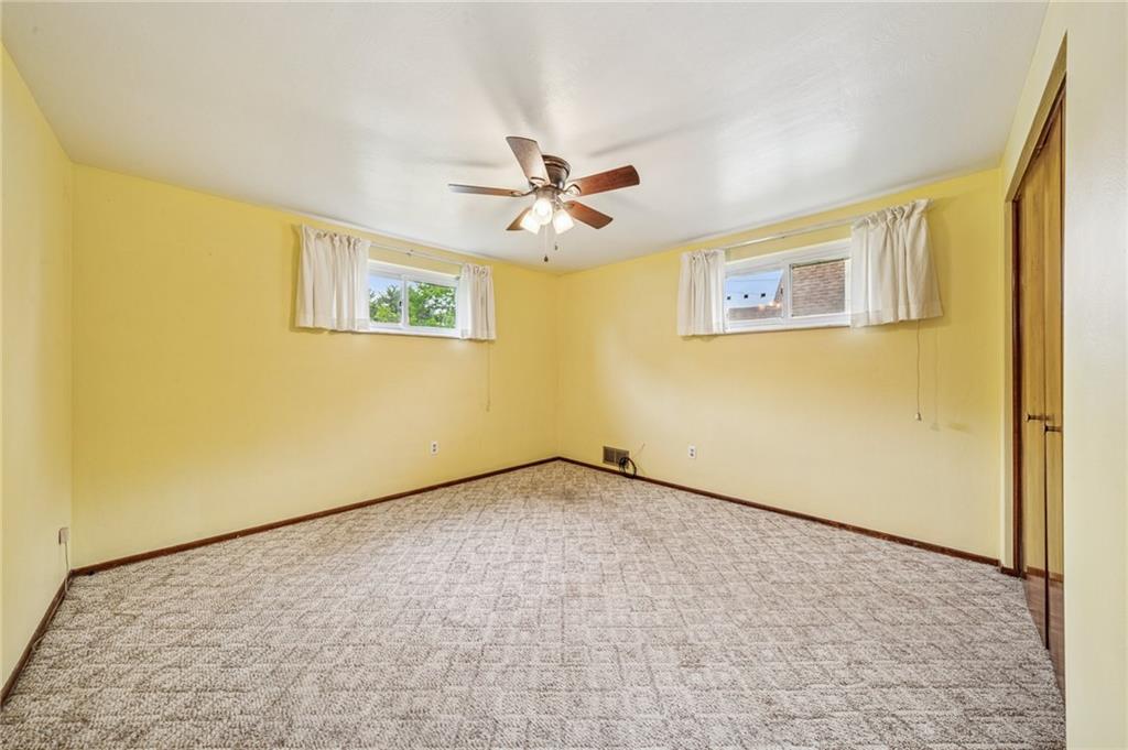 805 Willow Street Irwin, PA 15642 - Photo 9 of 33 an empty room with a ceiling fan and window