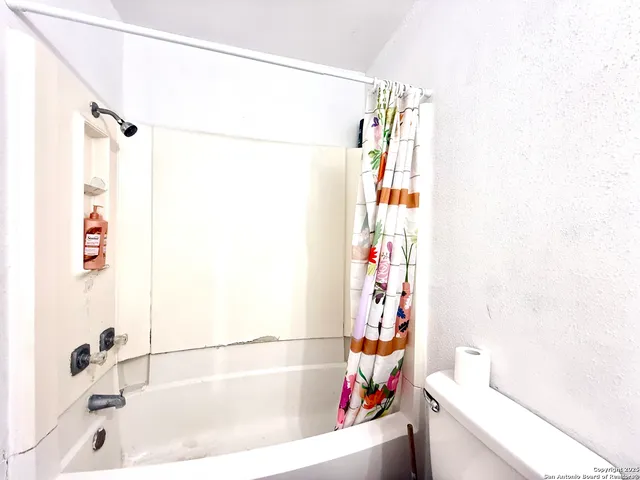 a bathroom with a bathtub and shower