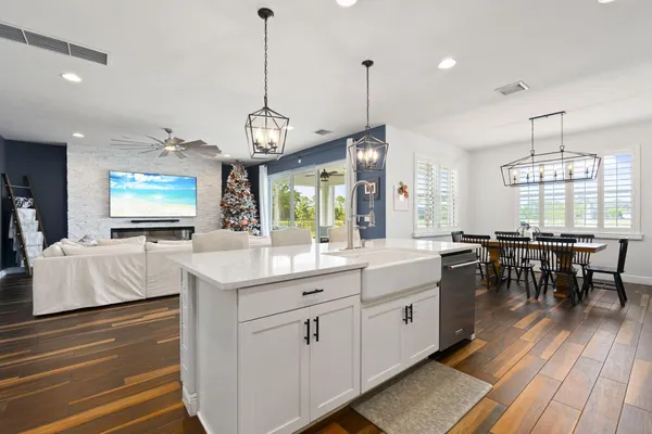 a large kitchen with lots of counter space and chandelier