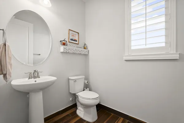 a bathroom with a toilet sink and mirror
