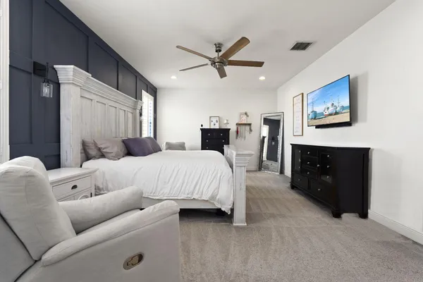 a bed room with a bed and a television