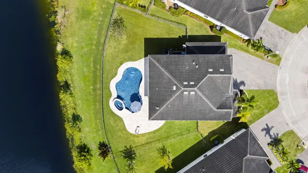 an aerial view of a house with a swimming pool yard and outdoor seating