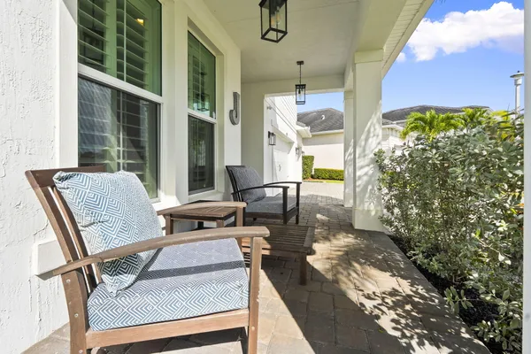 a balcony with table and chairs