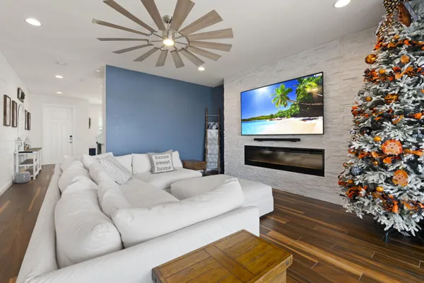 a living room with furniture a fireplace and a flat screen tv
