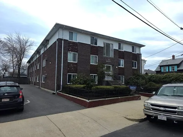 a view of a car park in front of house