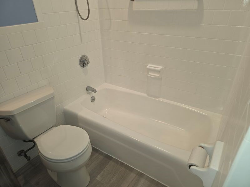70 Mudge Street, Unit 12 Lynn, MA 01902 - Photo 17 of 22 a white toilet sitting next to a bath tub