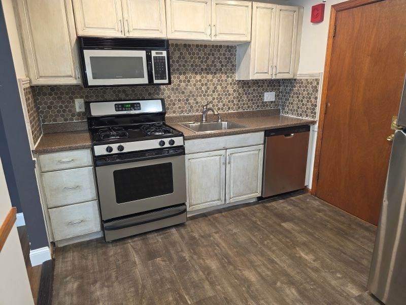 70 Mudge Street, Unit 12 Lynn, MA 01902 - Photo 2 of 22 a kitchen with stainless steel appliances granite countertop a stove a sink and a microwave