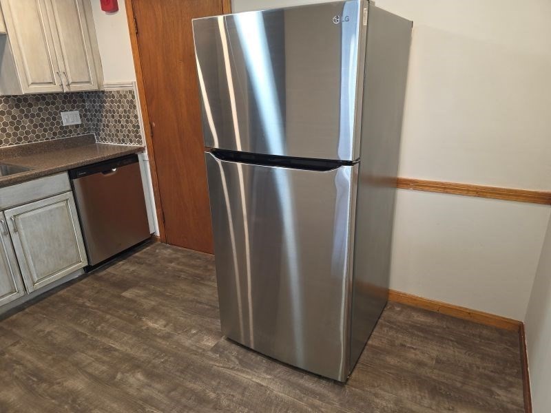 70 Mudge Street, Unit 12 Lynn, MA 01902 - Photo 4 of 22 a view of a refrigerator in kitchen and an empty room