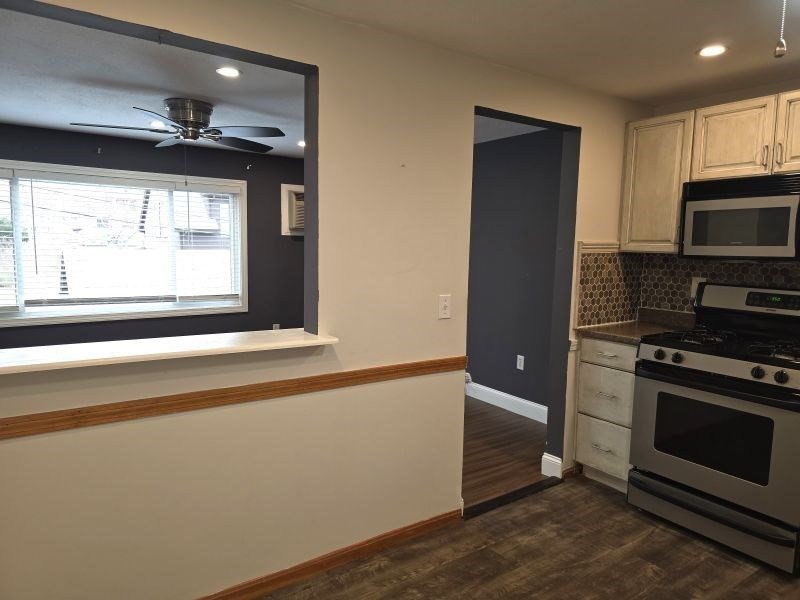 70 Mudge Street, Unit 12 Lynn, MA 01902 - Photo 5 of 22 a kitchen with a stove and a microwave