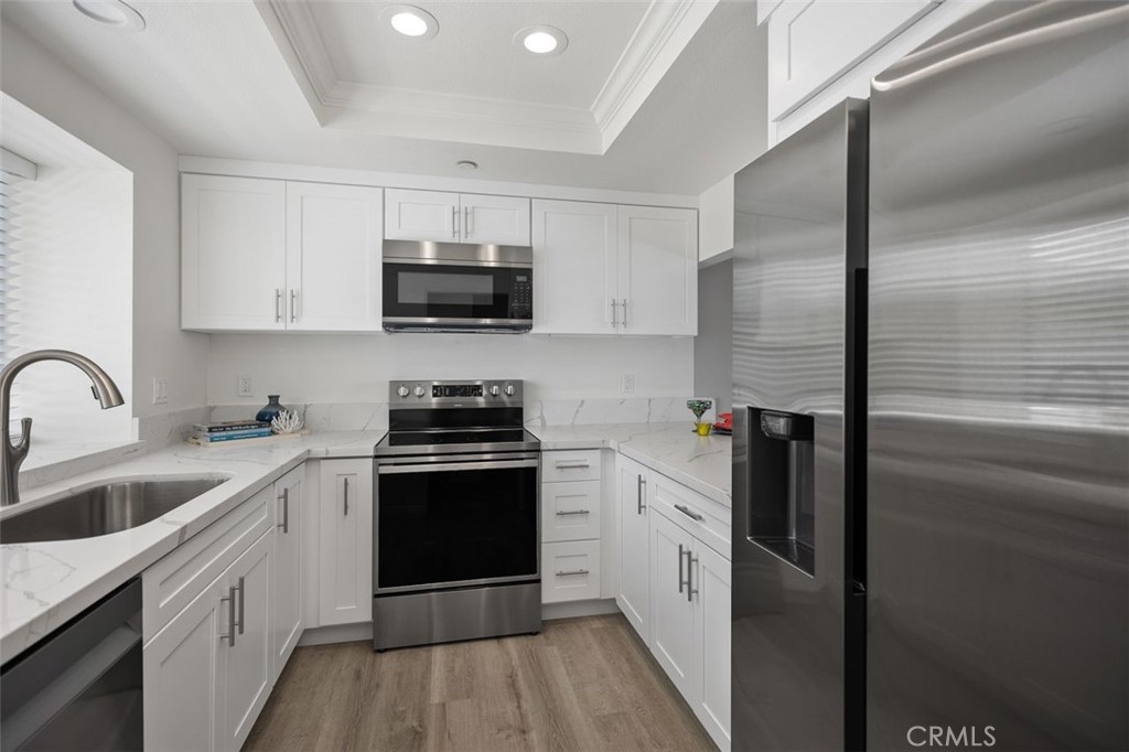 2031 Via Concha San Clemente, CA 92673 - Photo 10 of 29 a kitchen with stainless steel appliances granite countertop a refrigerator a sink and white cabinets