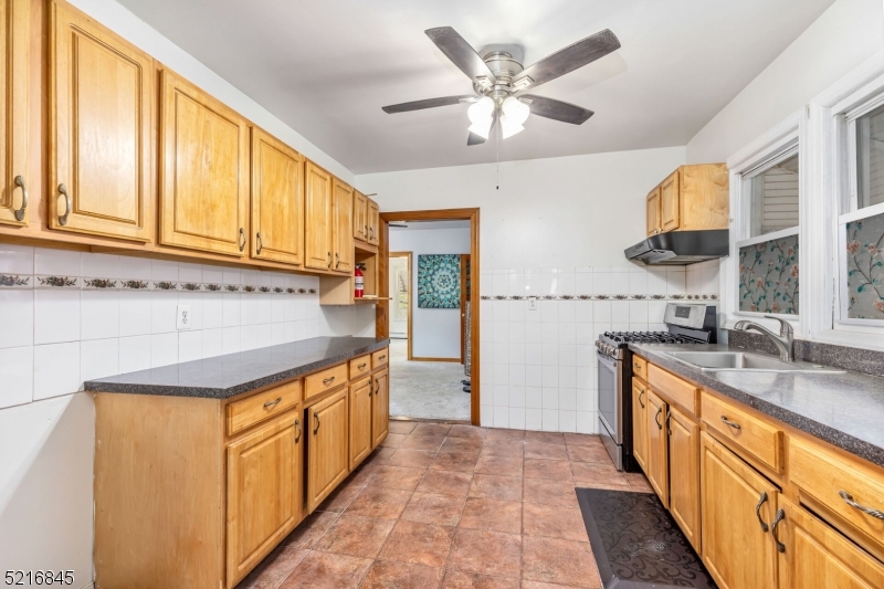 213 Linden Road, Unit 213 Roselle, NJ 07203 - Photo 12 of 14 a kitchen with stainless steel appliances granite countertop a sink and a stove
