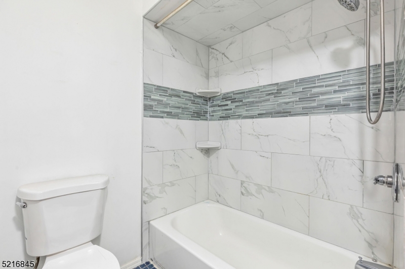 213 Linden Road, Unit 213 Roselle, NJ 07203 - Photo 13 of 14 a bathroom with a bathtub and toilet