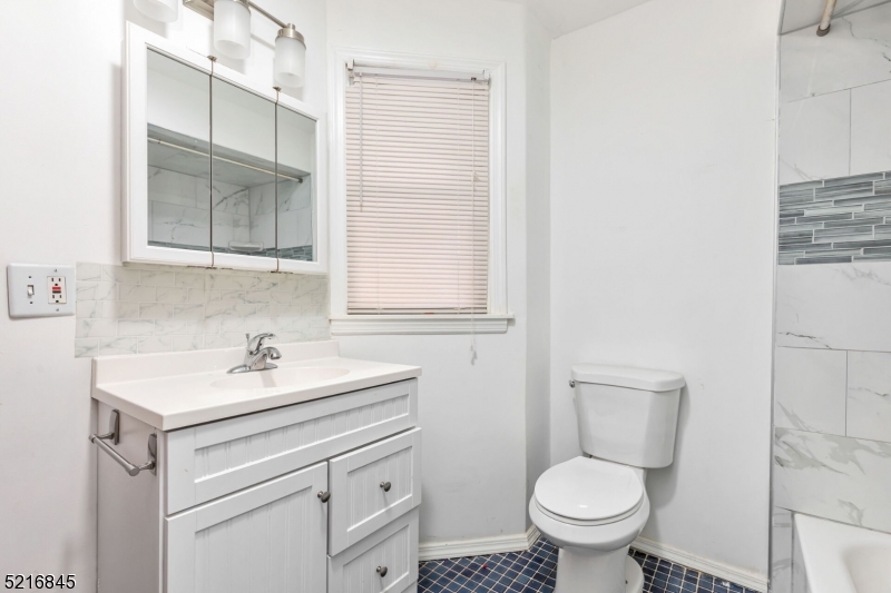 213 Linden Road, Unit 213 Roselle, NJ 07203 - Photo 14 of 14 a bathroom with a sink toilet vanity and mirror