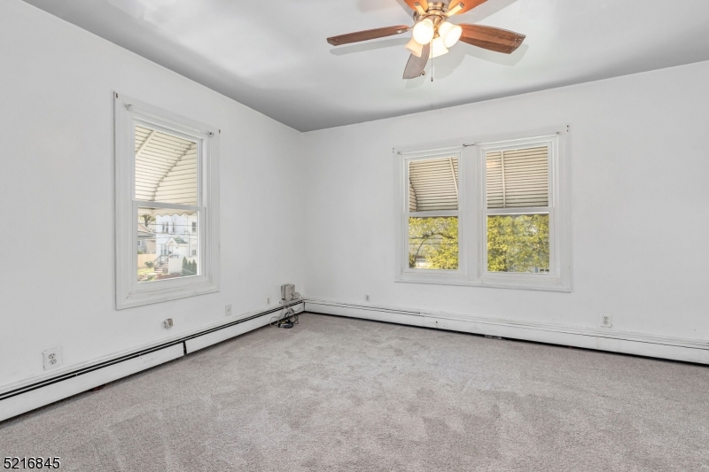 213 Linden Road, Unit 213 Roselle, NJ 07203 - Photo 5 of 14 an empty room with windows and fan